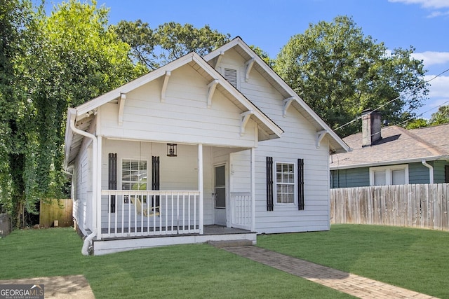 view of front of home featuring a front yard and a porch