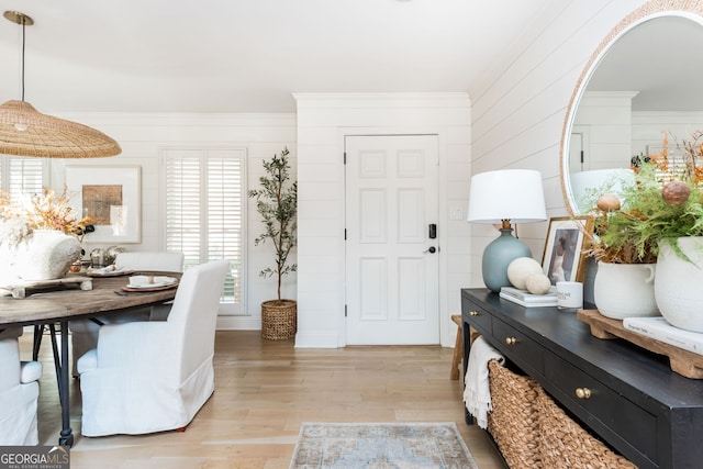 interior space featuring crown molding and light hardwood / wood-style floors