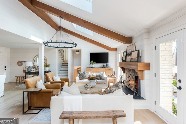 living room featuring lofted ceiling with skylight and light wood-type flooring