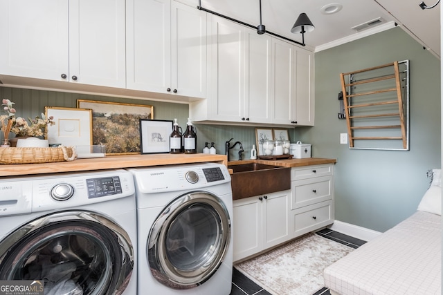 clothes washing area featuring ornamental molding, washer and dryer, sink, and tile patterned floors