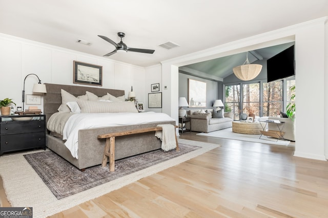 bedroom with ceiling fan, ornamental molding, wood-type flooring, and vaulted ceiling