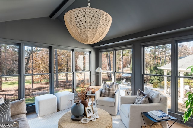 sunroom featuring lofted ceiling with beams