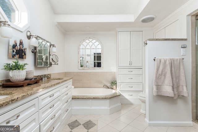 bathroom featuring tile patterned flooring, vanity, a tub, and toilet