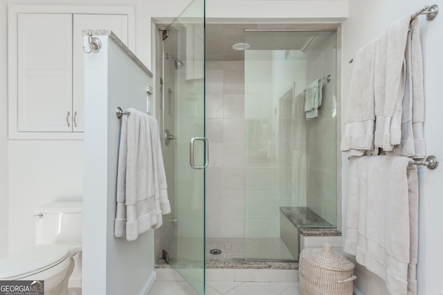 bathroom featuring toilet and an enclosed shower