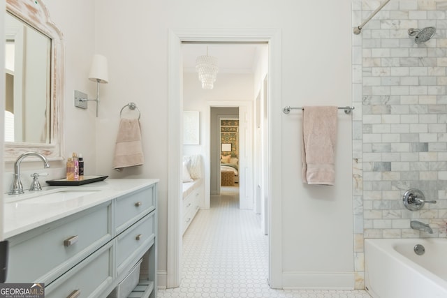 bathroom with vanity, ornamental molding, and tiled shower / bath