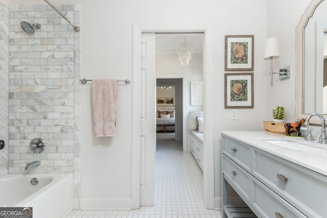 bathroom featuring vanity, ornamental molding, and tiled shower / bath