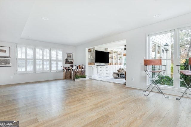 unfurnished living room with ceiling fan and light hardwood / wood-style floors