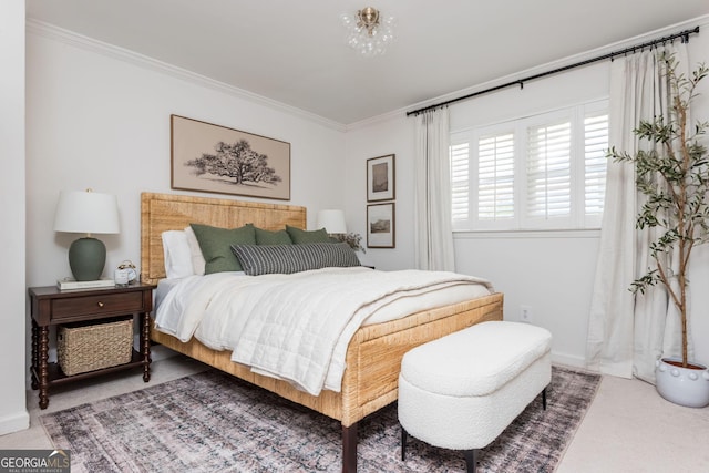 bedroom with ornamental molding and carpet flooring