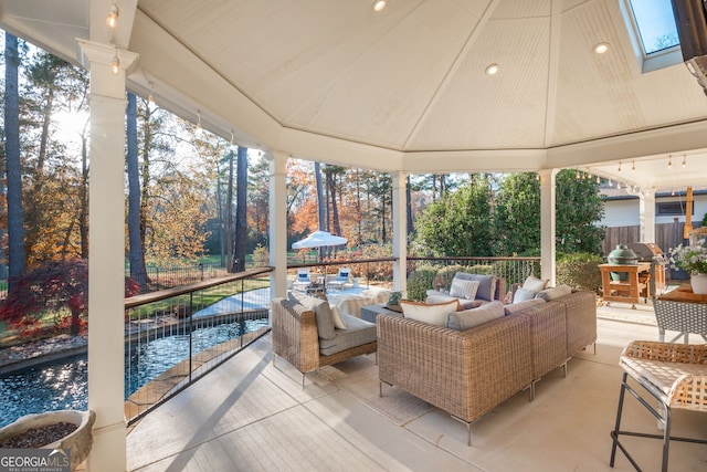 sunroom featuring vaulted ceiling and a healthy amount of sunlight