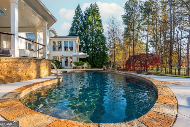 view of swimming pool featuring french doors