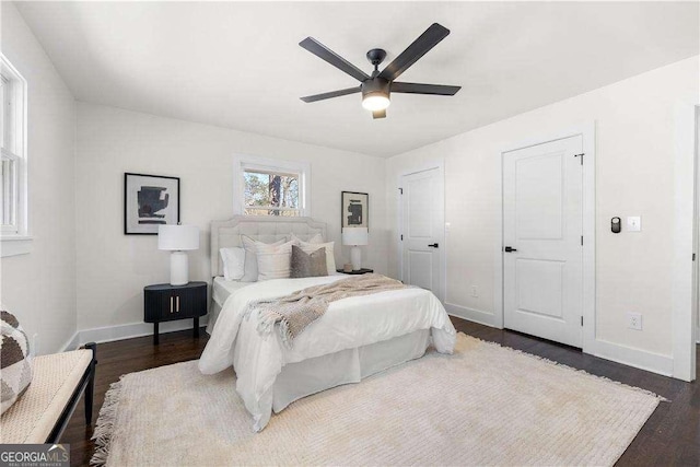 bedroom featuring ceiling fan and dark wood-type flooring