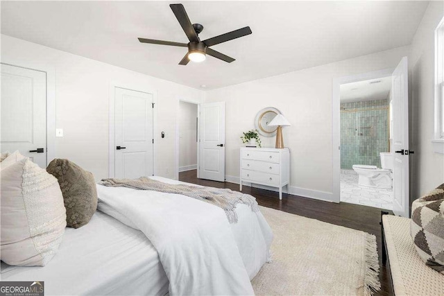 bedroom featuring ceiling fan, dark hardwood / wood-style floors, and ensuite bath