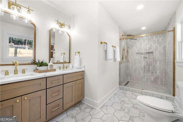 bathroom with an enclosed shower, vanity, and toilet