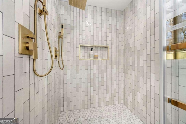 bathroom with tiled shower