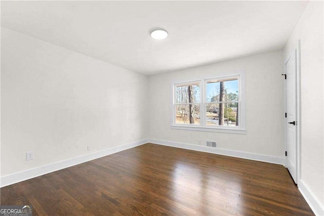 unfurnished room featuring dark wood-type flooring