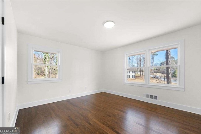 spare room featuring dark wood-type flooring