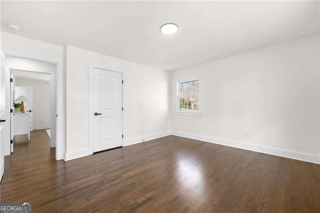 empty room with dark wood-type flooring