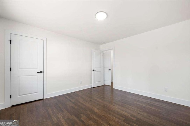 empty room featuring dark hardwood / wood-style floors