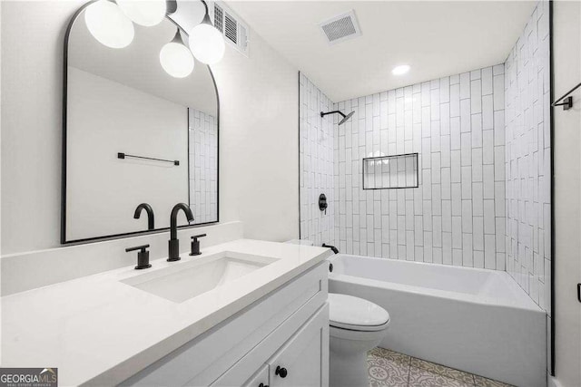 full bathroom featuring vanity, toilet, and tiled shower / bath combo