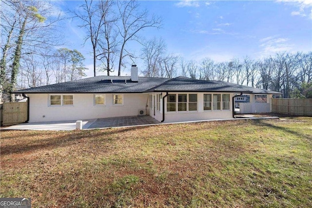 back of house featuring a patio and a yard