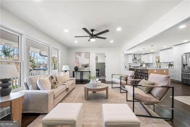 living room featuring ceiling fan and light hardwood / wood-style floors