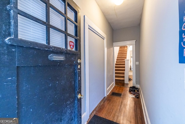 corridor with hardwood / wood-style floors