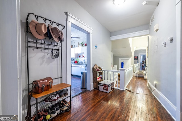 hallway with sink and dark hardwood / wood-style flooring