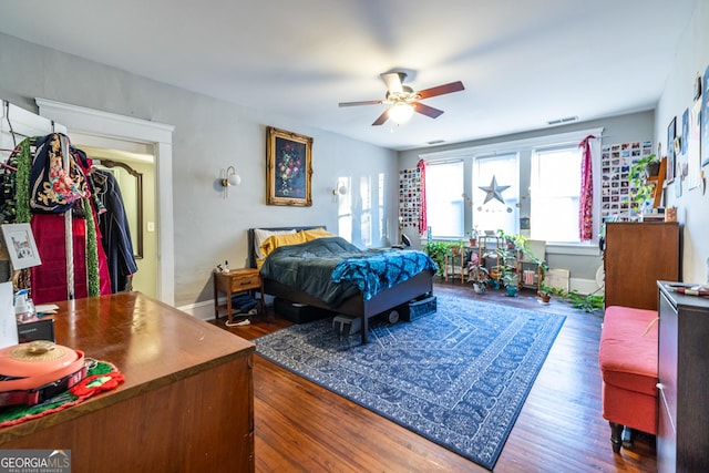 bedroom featuring ceiling fan and dark hardwood / wood-style flooring