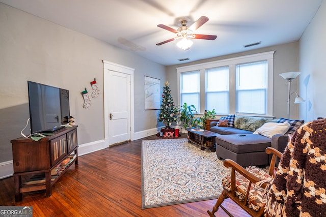 living room with ceiling fan and dark hardwood / wood-style floors