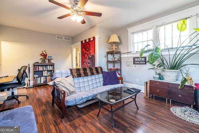 living room featuring ceiling fan and dark hardwood / wood-style flooring