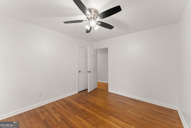 unfurnished bedroom with baseboards, a ceiling fan, and wood finished floors