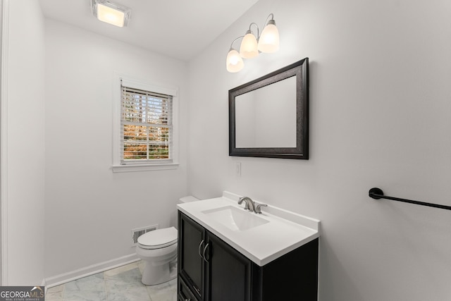 bathroom with vanity, marble finish floor, visible vents, baseboards, and toilet