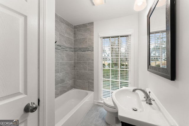 bathroom featuring visible vents, toilet, and tub / shower combination