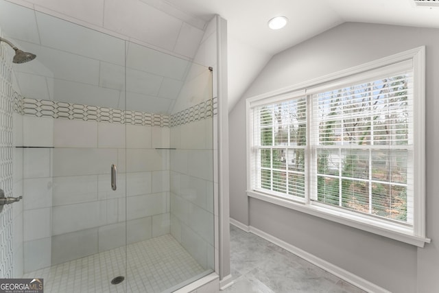 full bath with a shower stall, baseboards, vaulted ceiling, and visible vents