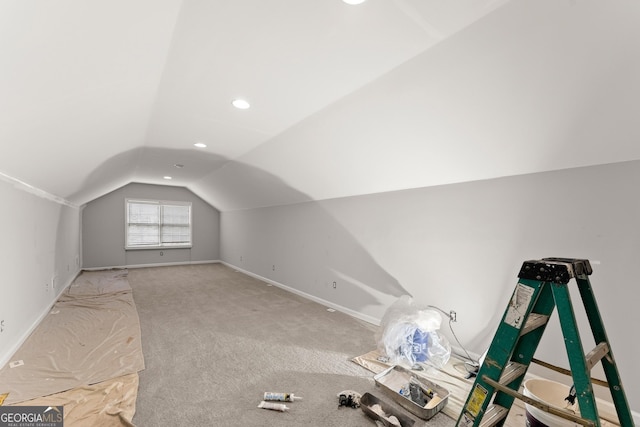 additional living space with recessed lighting, baseboards, lofted ceiling, and carpet