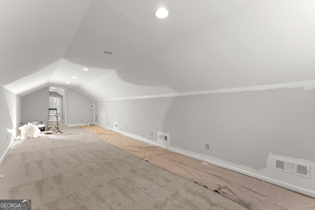 additional living space featuring vaulted ceiling, visible vents, recessed lighting, and light carpet