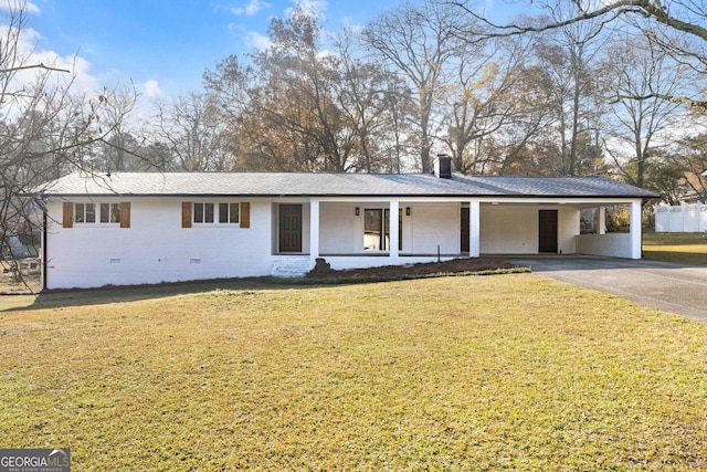 single story home with covered porch, a front yard, and a carport