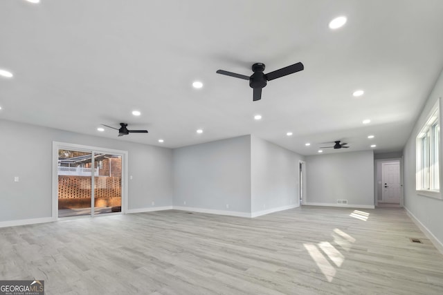 unfurnished living room featuring ceiling fan and light hardwood / wood-style flooring