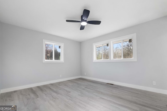 empty room featuring light wood-type flooring and ceiling fan