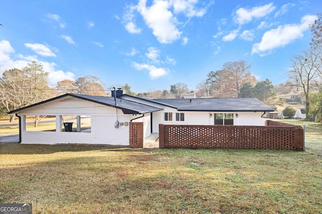 back of house featuring a patio area and a yard