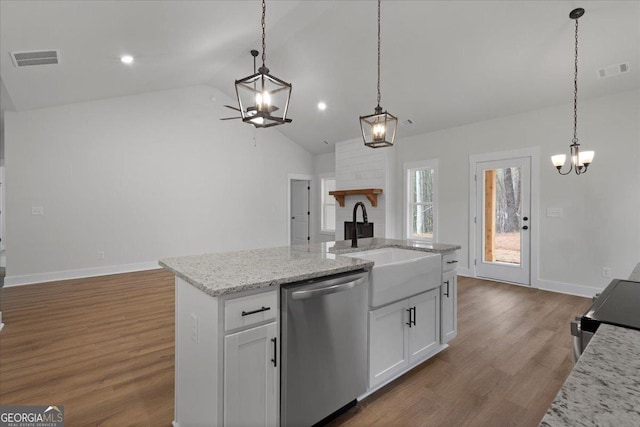 kitchen featuring sink, white cabinetry, decorative light fixtures, stainless steel dishwasher, and a kitchen island with sink