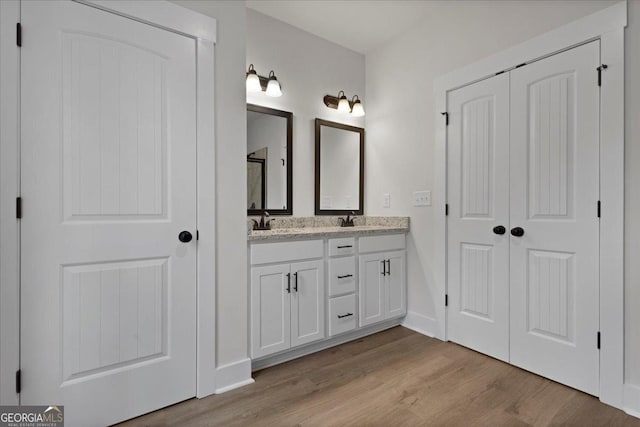 bathroom featuring wood-type flooring and vanity