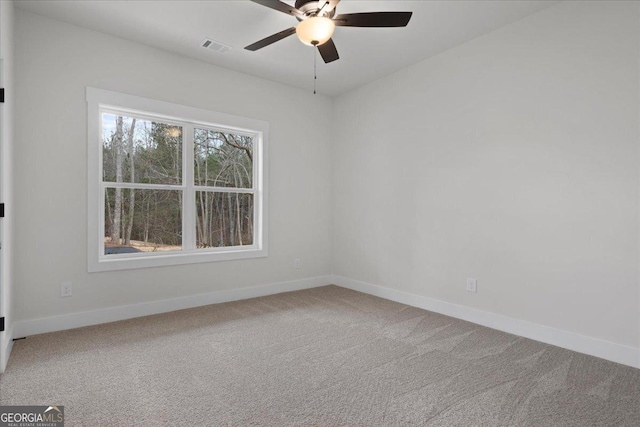 carpeted empty room featuring ceiling fan