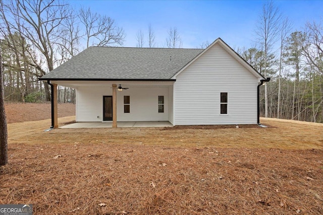 back of property featuring a lawn, ceiling fan, and a patio area