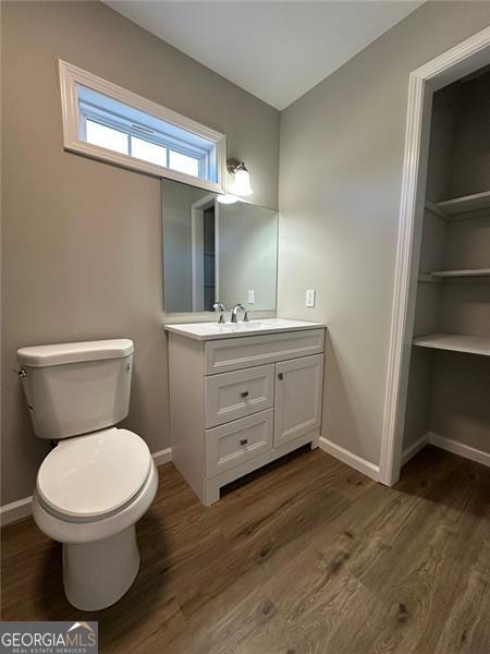 bathroom featuring hardwood / wood-style floors, toilet, and vanity