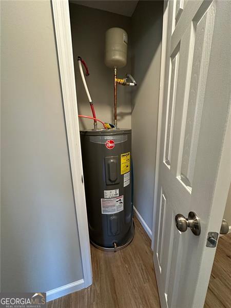 utility room featuring electric water heater