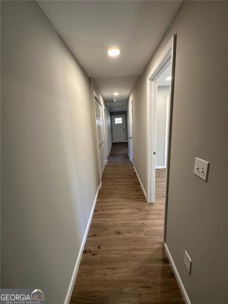 hallway with dark wood-type flooring