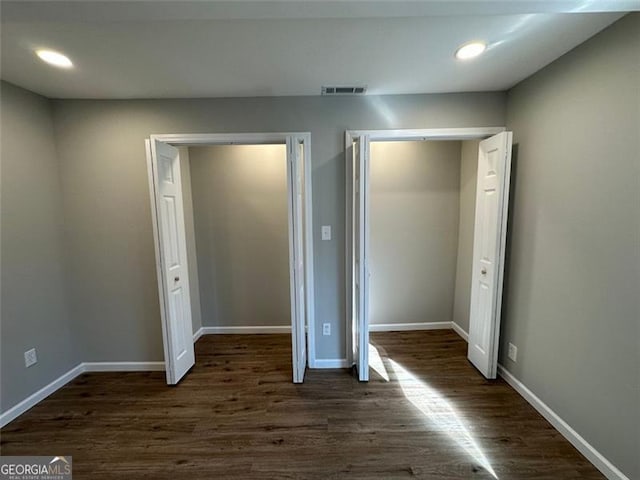 unfurnished bedroom with dark hardwood / wood-style floors