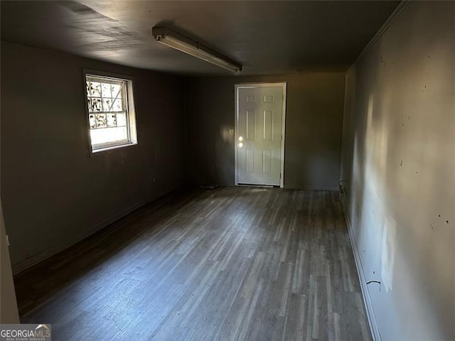 empty room with dark hardwood / wood-style flooring