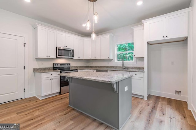 kitchen featuring white cabinetry and appliances with stainless steel finishes